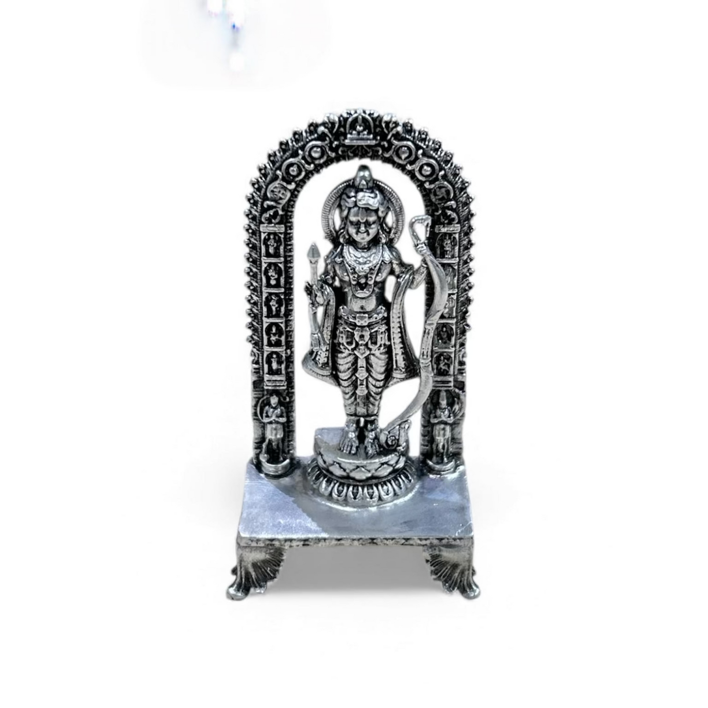 Silver statue of a deity on a white background